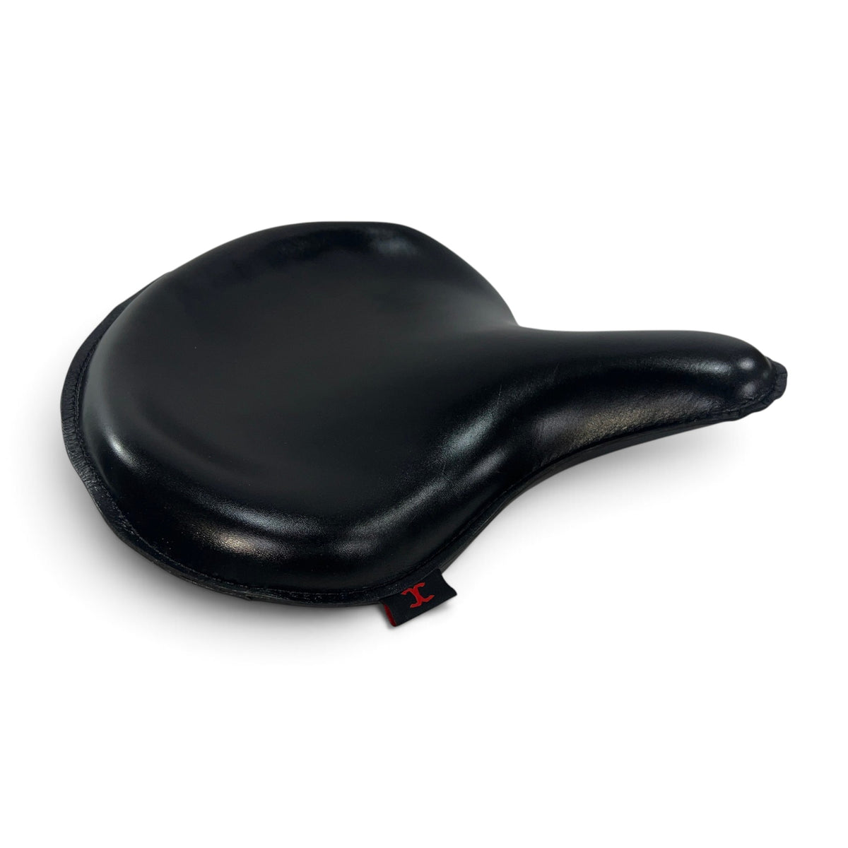 Champ Customs Shop black full grain leather solo seat for vintage Harley motorcycles with hand-stitched detailing.