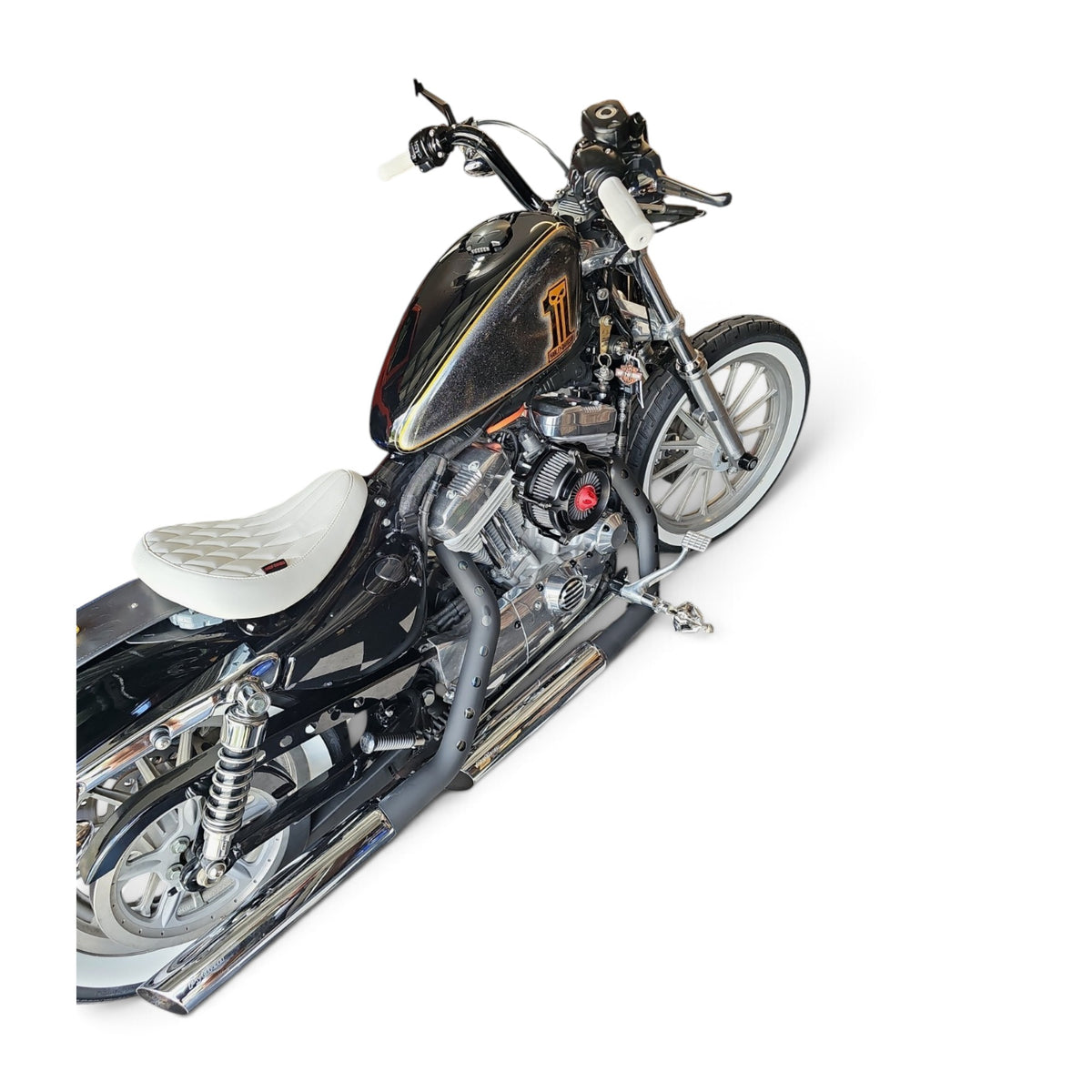 White diamond-stitched solo seat installed on a black Harley-Davidson Sportster motorcycle