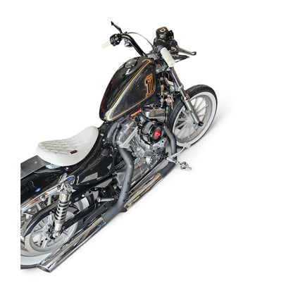 White diamond-stitched solo seat installed on a black Harley-Davidson Sportster motorcycle